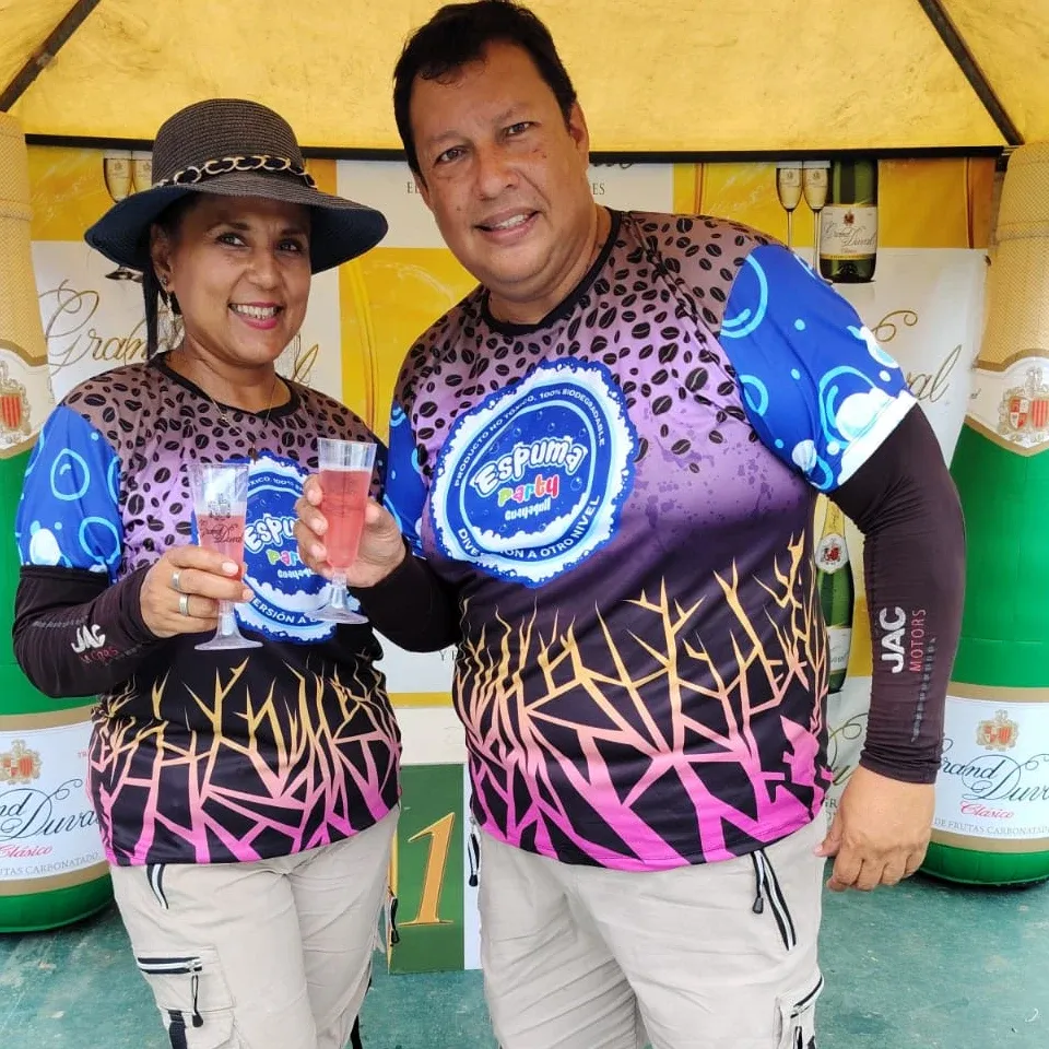 Los dueños de Espuma Party Guayaquil con las camisetas de la marca, brindando en un evento
